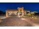 Luxury home exterior with a large garage and attractive landscaping at 9633 E Quarter Circle Loop, Gold Canyon, AZ 85118