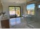 Spa-like bathroom with a freestanding tub, walk-in shower, and marble floors at 9633 E Quarter Circle Loop, Gold Canyon, AZ 85118