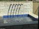 Private outdoor spa with a cascading water feature and stone wall at 9633 E Quarter Circle Loop, Gold Canyon, AZ 85118