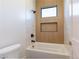 Clean bathroom with a bathtub and wood-look wall detail at 9633 E Quarter Circle Loop, Gold Canyon, AZ 85118