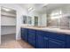 Double vanity bathroom with blue cabinets and a large mirror at 4506 W Maggie Dr, San Tan Valley, AZ 85144