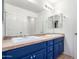 Bathroom with double vanity, blue cabinets, and a large mirror at 4506 W Maggie Dr, San Tan Valley, AZ 85144