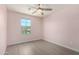 Bright bedroom with wood-look floors, ceiling fan, and window at 4506 W Maggie Dr, San Tan Valley, AZ 85144