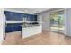 Modern kitchen with blue cabinets, granite countertops, and island at 4506 W Maggie Dr, San Tan Valley, AZ 85144