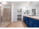Bathroom boasts a walk-in shower and double vanity with blue cabinets at 4506 W Maggie Dr, San Tan Valley, AZ 85144