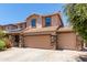Two-story house with solar panels, three car garage, and landscaped front yard at 4506 W Maggie Dr, San Tan Valley, AZ 85144