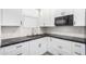Modern kitchen with white cabinets and black countertops at 4506 W Maggie Dr, San Tan Valley, AZ 85144