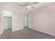 Bedroom with wood-look floors, ceiling fan, and access to closet and bathroom at 4506 W Maggie Dr, San Tan Valley, AZ 85144