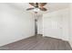 Bedroom with wood-like floors, ceiling fan, and mirrored closet doors at 4506 W Maggie Dr, San Tan Valley, AZ 85144