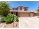 Two-story house with solar panels, three car garage, and landscaped front yard at 4506 W Maggie Dr, San Tan Valley, AZ 85144