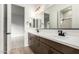 Modern bathroom with double vanity, dark wood cabinets, and black fixtures at 21864 E Saddle E Ct, Queen Creek, AZ 85142