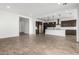 Open concept living room and kitchen area with tile flooring at 21864 E Saddle E Ct, Queen Creek, AZ 85142