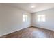 Spacious bedroom featuring wood-look floors and dual windows at 4943 E Indian School Rd # 4, Phoenix, AZ 85018