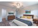 Main bedroom with dresser, large bed, and wood-look floors at 4943 E Indian School Rd # 4, Phoenix, AZ 85018