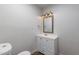 Clean bathroom with white vanity and framed mirror at 4943 E Indian School Rd # 4, Phoenix, AZ 85018