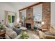 Cozy living room with exposed brick fireplace and comfortable seating at 730 E Mckinley St, Phoenix, AZ 85006