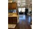 Open concept kitchen and living area with dark wood cabinets and flooring at 2460 E Main St # G3, Mesa, AZ 85213