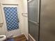 Bathroom features a shower and blue patterned curtain at 2460 E Main St # G3, Mesa, AZ 85213