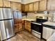 Kitchen with stainless steel appliances and wood cabinets at 2460 E Main St # G3, Mesa, AZ 85213