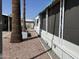 Side yard of mobile home with gravel, plants, and a fire pit at 2460 E Main St # G3, Mesa, AZ 85213