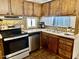 Kitchen with dark wood cabinets and stainless steel appliances at 2460 E Main St # G3, Mesa, AZ 85213