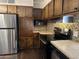 Stainless steel appliances and wood cabinets in kitchen at 2460 E Main St # G3, Mesa, AZ 85213