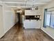 Bright living room with laminate wood floors and kitchen view at 2460 E Main St # G3, Mesa, AZ 85213