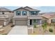 Two-story house with gray exterior and blue shutters at 18361 W Jessie Ln, Surprise, AZ 85387