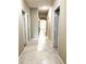 Long hallway with tile flooring and access to multiple rooms at 21978 N Dietz Dr, Maricopa, AZ 85138