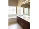 Double vanity bathroom with large mirror and built in cabinets at 21978 N Dietz Dr, Maricopa, AZ 85138