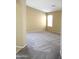 Bright and spacious living room with carpeted floors and neutral wall tones at 21978 N Dietz Dr, Maricopa, AZ 85138