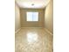 Well-lit bedroom with tile flooring and neutral wall colors at 21978 N Dietz Dr, Maricopa, AZ 85138