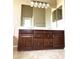 Double vanity bathroom with large mirror and wood cabinets at 21978 N Dietz Dr, Maricopa, AZ 85138