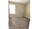 Spacious bedroom with neutral carpet and large window at 21978 N Dietz Dr, Maricopa, AZ 85138