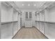 Spacious walk-in closet, complete with built-in shelving and drawers at 39220 N 30Th Dr, Phoenix, AZ 85086