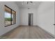 Bright bedroom with large window and wood-look flooring at 39220 N 30Th Dr, Phoenix, AZ 85086