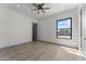 Bright bedroom with large window, hardwood floors, and ceiling fan at 39220 N 30Th Dr, Phoenix, AZ 85086