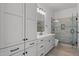 Modern bathroom with white cabinets, tile shower, and ample storage at 39220 N 30Th Dr, Phoenix, AZ 85086