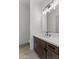 Modern bathroom with dark brown vanity and a large mirror at 39220 N 30Th Dr, Phoenix, AZ 85086