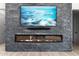 Modern linear fireplace with a large flat-screen TV above at 39220 N 30Th Dr, Phoenix, AZ 85086