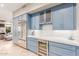 Kitchen features blue cabinets, marble counters, and wine fridge at 8919 E Calle Del Palo Verde --, Scottsdale, AZ 85255