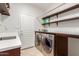 Laundry room with washer, dryer, and shelving at 8919 E Calle Del Palo Verde --, Scottsdale, AZ 85255