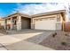 Front exterior of single-story home with paved driveway and attached two-car garage at 21881 E Saddle Ct, Queen Creek, AZ 85142