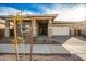 Attractive single-story home with a paver driveway and front yard landscaping at 21881 E Saddle Ct, Queen Creek, AZ 85142