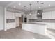 Modern kitchen with white cabinets, quartz countertops, stainless steel appliances, and an island at 21881 E Saddle Ct, Queen Creek, AZ 85142