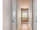 Long bathroom hallway with a large bathtub and natural light at 16738 E Lone Mountain Rd, Scottsdale, AZ 85262