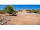 Landscaped front yard with a rock retaining wall and desert landscaping at 16738 E Lone Mountain Rd, Scottsdale, AZ 85262