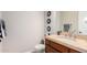 Bathroom with a single sink vanity and wood cabinets at 16738 E Lone Mountain Rd, Scottsdale, AZ 85262
