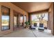 Relaxing covered patio with lounge chairs, offering a tranquil outdoor space at 16738 E Lone Mountain Rd, Scottsdale, AZ 85262