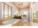 Spa-like bathroom with soaking tub and glass-block shower at 16738 E Lone Mountain Rd, Scottsdale, AZ 85262